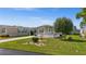 Well-maintained home with a landscaped yard and driveway at 9085 Pinehaven Way, Englewood, FL 34224