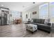 Open living area with gray sofa and dining table at 9085 Pinehaven Way, Englewood, FL 34224