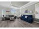 Bright living room with comfy sofas, large windows, and wood-look floors at 9085 Pinehaven Way, Englewood, FL 34224