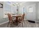 Cozy dining area with wooden table and chairs, near kitchen at 9085 Pinehaven Way, Englewood, FL 34224