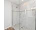 Large walk-in shower with marble-style tile and pebble floor at 4199 Hollis Ave, Port Charlotte, FL 33953