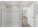 Walk-in shower with marble-style tile and pebble floor at 4199 Hollis Ave, Port Charlotte, FL 33953