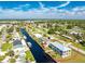 An aerial view of a waterfront home with a private dock and a large backyard at 4199 Hollis Ave, Port Charlotte, FL 33953