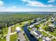 An aerial view of a canal-side home in a quiet residential area with water access at 4199 Hollis Ave, Port Charlotte, FL 33953