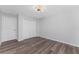 Simple bedroom with double door closet and wood-look floors at 4199 Hollis Ave, Port Charlotte, FL 33953
