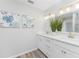 Double vanity bathroom with white cabinets and quartz countertop at 4199 Hollis Ave, Port Charlotte, FL 33953