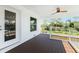 Spacious deck with dark wood flooring, ceiling fan, and glass door access at 4199 Hollis Ave, Port Charlotte, FL 33953