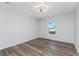 Spacious bedroom with wood-look floors and a large window offering natural light at 4199 Hollis Ave, Port Charlotte, FL 33953