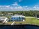 Aerial view of waterfront home with metal roof, elevated design, and private dock at 4199 Hollis Ave, Port Charlotte, FL 33953