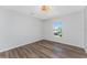 Bright bedroom with wood-look floors and a window at 4199 Hollis Ave, Port Charlotte, FL 33953