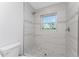 Walk-in shower with pebble floor and modern fixtures at 4199 Hollis Ave, Port Charlotte, FL 33953