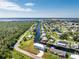 Aerial view of waterfront property with canal access and lush landscaping at 4199 Hollis Ave, Port Charlotte, FL 33953