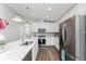 Modern kitchen with stainless steel appliances and white cabinets at 4199 Hollis Ave, Port Charlotte, FL 33953