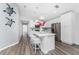 Open concept kitchen with white cabinets, island, and stylish light fixtures at 4199 Hollis Ave, Port Charlotte, FL 33953