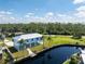Elevated view of a modern waterfront home with a metal roof and private dock at 4199 Hollis Ave, Port Charlotte, FL 33953