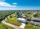 Aerial view of waterfront property with canal access and lush landscaping at 4199 Hollis Ave, Port Charlotte, FL 33953