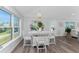 Bright dining area with white table and chairs near large windows at 4199 Hollis Ave, Port Charlotte, FL 33953