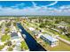 Aerial view of a modern two-story house situated on a canal with water access at 4199 Hollis Ave, Port Charlotte, FL 33953