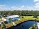 Modern home on stilts with canal access, surrounded by lush greenery at 4199 Hollis Ave, Port Charlotte, FL 33953