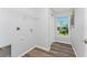 Bright laundry room features shelving, window, and vinyl flooring at 4199 Hollis Ave, Port Charlotte, FL 33953