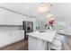 White kitchen with stainless steel appliances and large island at 4199 Hollis Ave, Port Charlotte, FL 33953