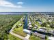 Aerial view of waterfront property with canal access and lush landscape at 4199 Hollis Ave, Port Charlotte, FL 33953