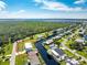 Aerial view showcasing a single-Gathering home on a canal in a residential neighborhood at 4199 Hollis Ave, Port Charlotte, FL 33953