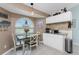 Eat-in kitchen with white cabinets, granite counters, and a charming window seat at 13511 Foresman Blvd, Port Charlotte, FL 33981