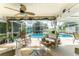 Inviting screened pool area with patio furniture and lush landscaping at 13511 Foresman Blvd, Port Charlotte, FL 33981