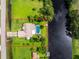 An aerial view of a home with a pool and canal-front property at 13511 Foresman Blvd, Port Charlotte, FL 33981