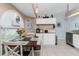 Bright kitchen boasts white cabinets, granite countertops and a breakfast nook at 13511 Foresman Blvd, Port Charlotte, FL 33981