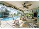 Relaxing pool area with a screened enclosure and comfy seating at 13511 Foresman Blvd, Port Charlotte, FL 33981