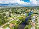 Wide aerial view showing the neighborhood and canal at 13511 Foresman Blvd, Port Charlotte, FL 33981