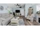 Living room with vaulted ceiling, light blue walls, and coastal decor at 13511 Foresman Blvd, Port Charlotte, FL 33981
