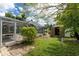 Backyard view showcasing the pool, shed, and lush landscape at 13511 Foresman Blvd, Port Charlotte, FL 33981