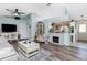 Living room with hardwood floors, vaulted ceilings, and a view into the kitchen at 13511 Foresman Blvd, Port Charlotte, FL 33981
