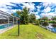 Spacious backyard with canal views, lush landscaping, and a dock at 13511 Foresman Blvd, Port Charlotte, FL 33981
