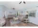 Bright living room with hardwood floors, neutral color palette, and access to other rooms at 13511 Foresman Blvd, Port Charlotte, FL 33981
