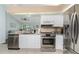 Modern kitchen featuring stainless steel appliances and granite countertops at 13511 Foresman Blvd, Port Charlotte, FL 33981