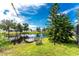 Peaceful backyard setting with a canal-side dock and lush greenery at 13511 Foresman Blvd, Port Charlotte, FL 33981