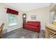 Living room with red couch and wood-look flooring at 13511 Foresman Blvd, Port Charlotte, FL 33981