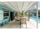 Relaxing pool area with patio furniture and screened enclosure at 13511 Foresman Blvd, Port Charlotte, FL 33981