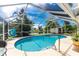 Inviting screened pool and patio area with a view of the lake at 13511 Foresman Blvd, Port Charlotte, FL 33981