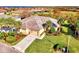 Aerial view of single-story home with tile roof, landscaping, and a two-car garage at 13534 Eagle Pointe Dr, Port Charlotte, FL 33953