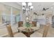 Kitchen dining area with glass table and wicker chairs, near sliding doors at 13534 Eagle Pointe Dr, Port Charlotte, FL 33953