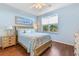 Light and airy bedroom with wicker bed frame and wood floors at 10055 Links Ln # 206, Rotonda West, FL 33947