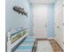 Bright entryway with a painted bench and tile flooring at 10055 Links Ln # 206, Rotonda West, FL 33947