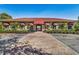 Community clubhouse with inviting entryway and red awnings at 10055 Links Ln # 206, Rotonda West, FL 33947