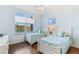Guest bedroom with twin beds and lake view at 10055 Links Ln # 206, Rotonda West, FL 33947
