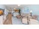 Open living room with light leather sofas and wood flooring at 10055 Links Ln # 206, Rotonda West, FL 33947
